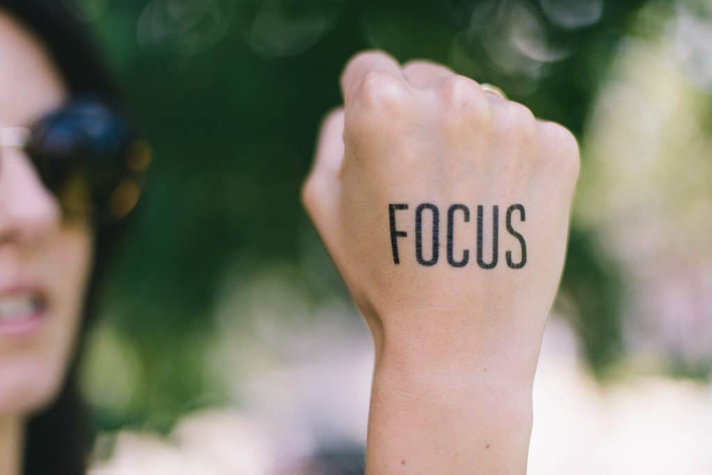 how to get focused - women with focus written on her hand