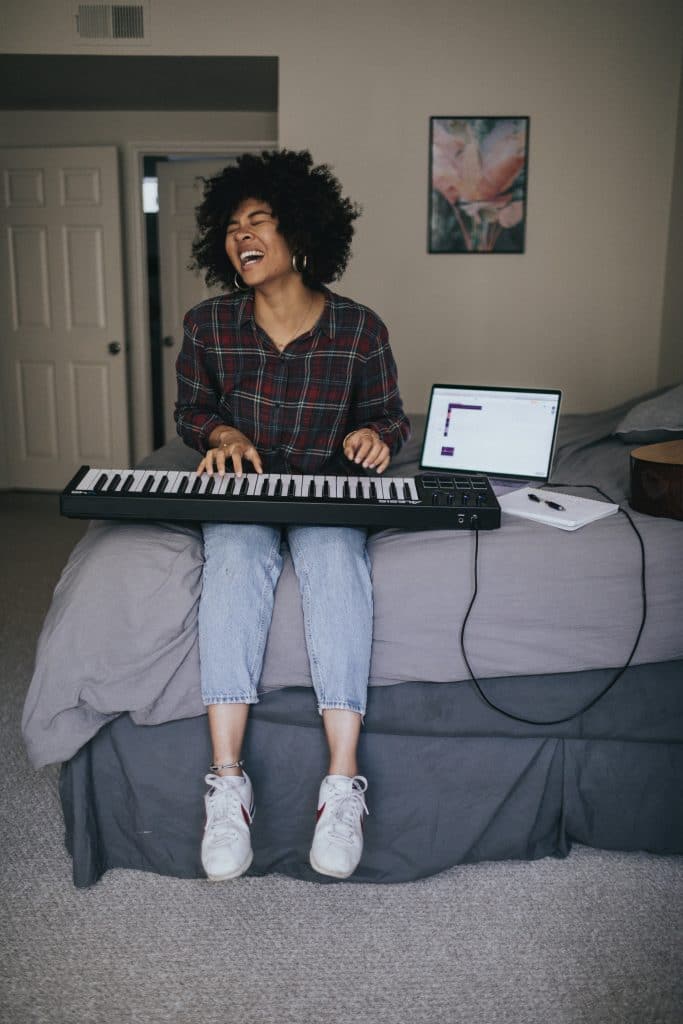 woman playing keyboard and singing