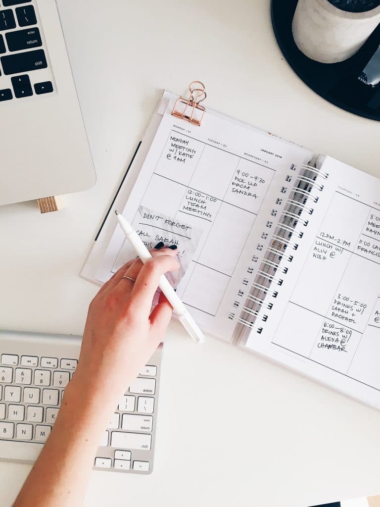 How to prioritize - hand on top of planner