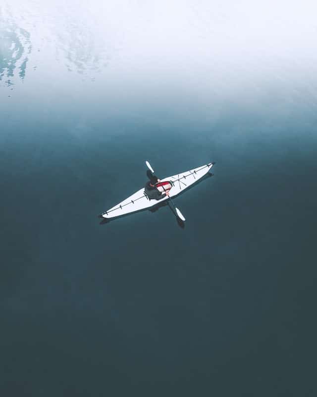 Embrace solitude - person in kayak