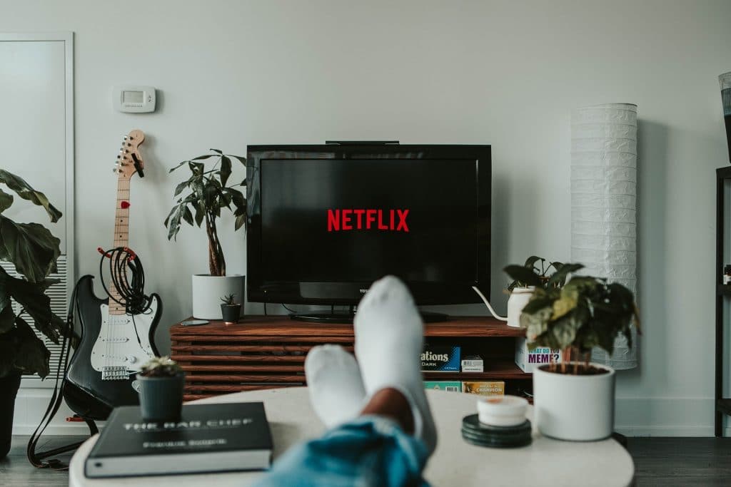 Feet up on a coffee table while watching Netflix