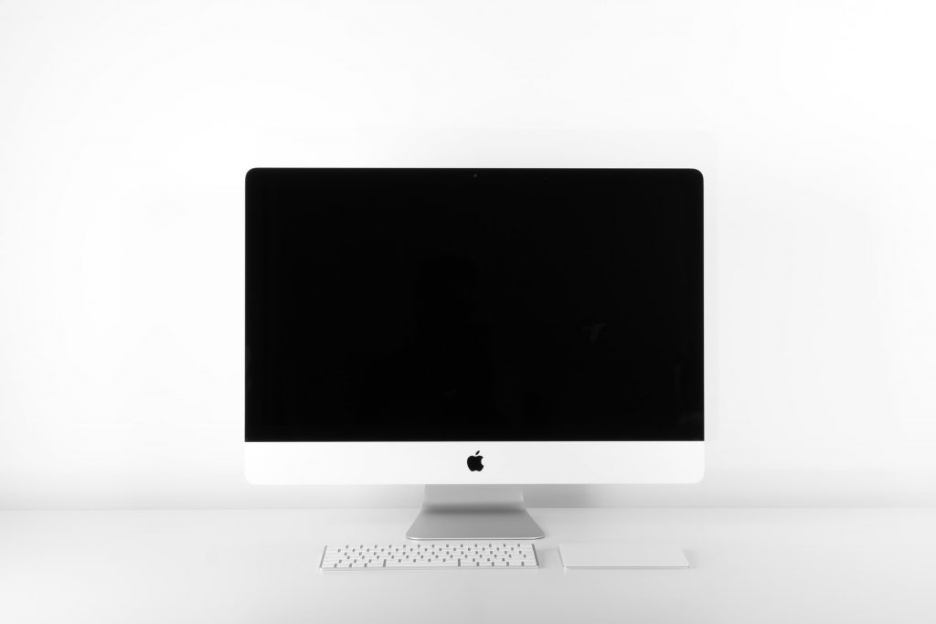 iMac sitting on white surface - minimalist