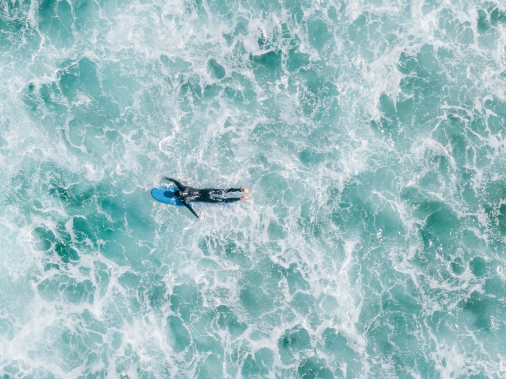 surfer paddling in the ocean