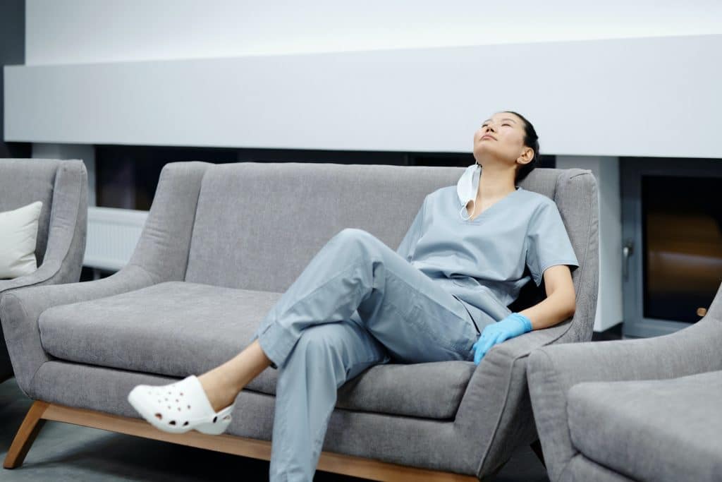 female medical worker taking a break on couch