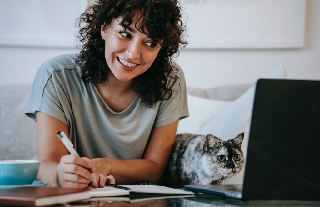 woman working from home with cat