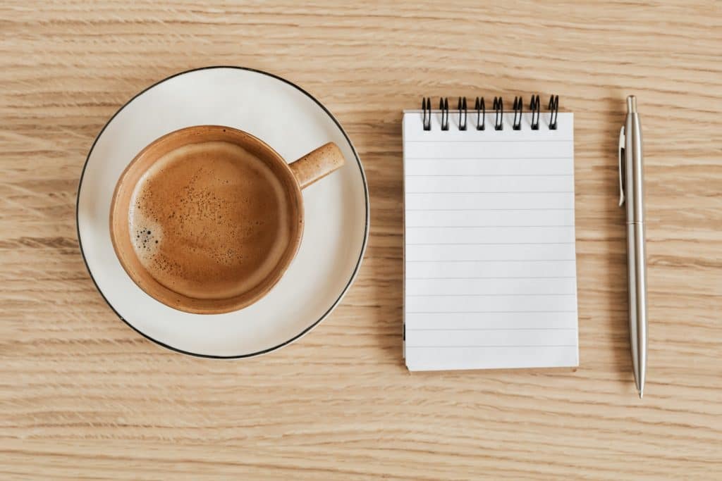 coffee cup blank notepad and pen on desk