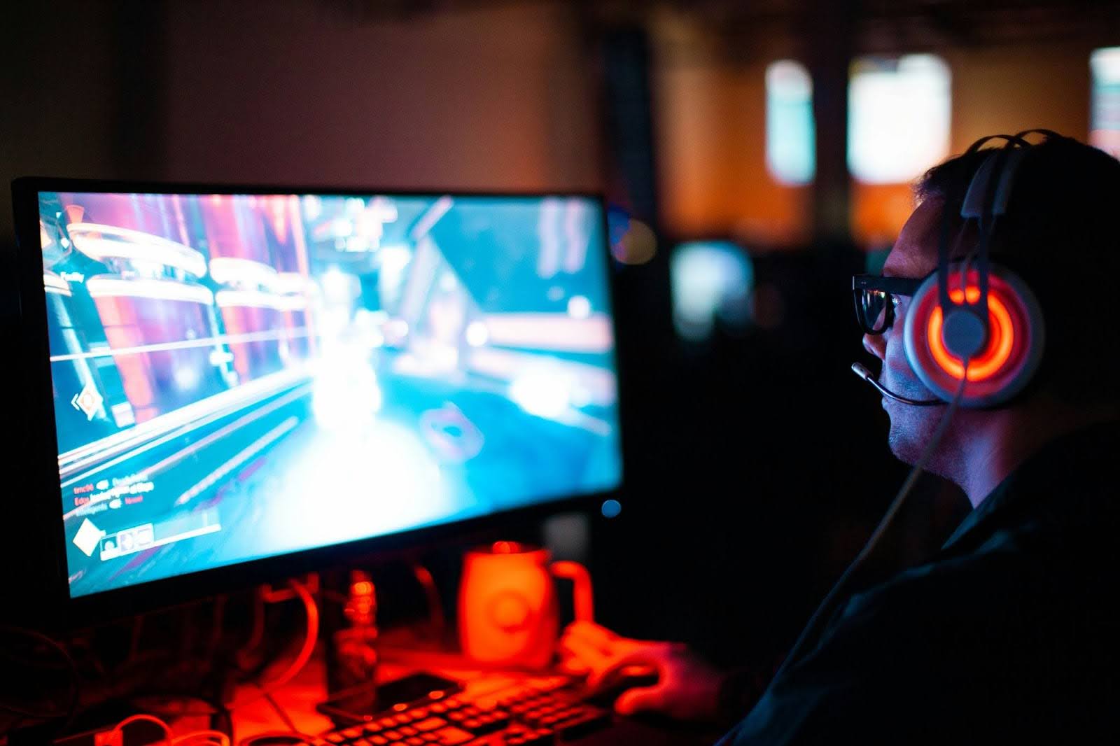 A man engrossed in a video game, displaying signs of gaming addiction with intense focus