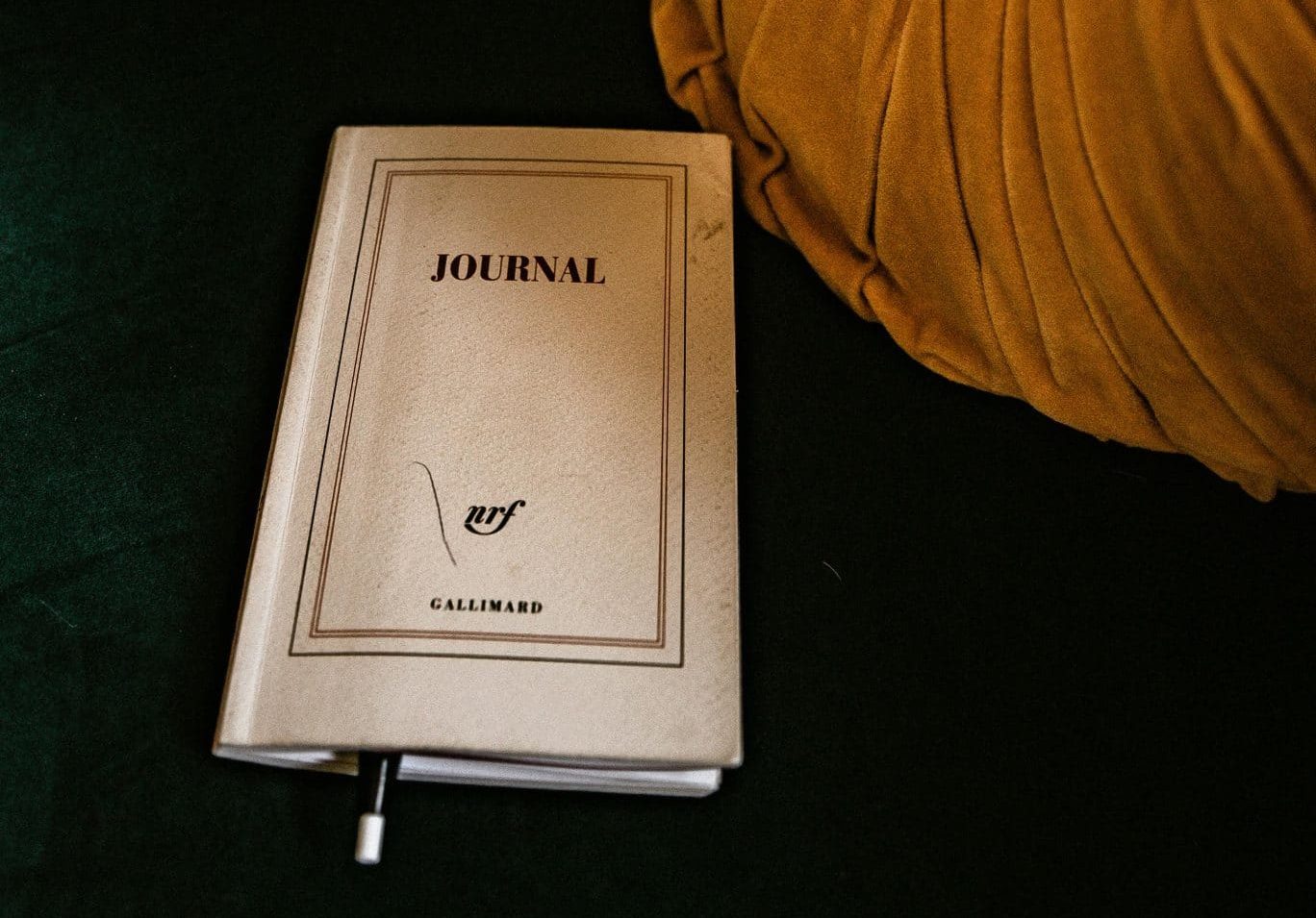 A closed journal with a pen left inside it.