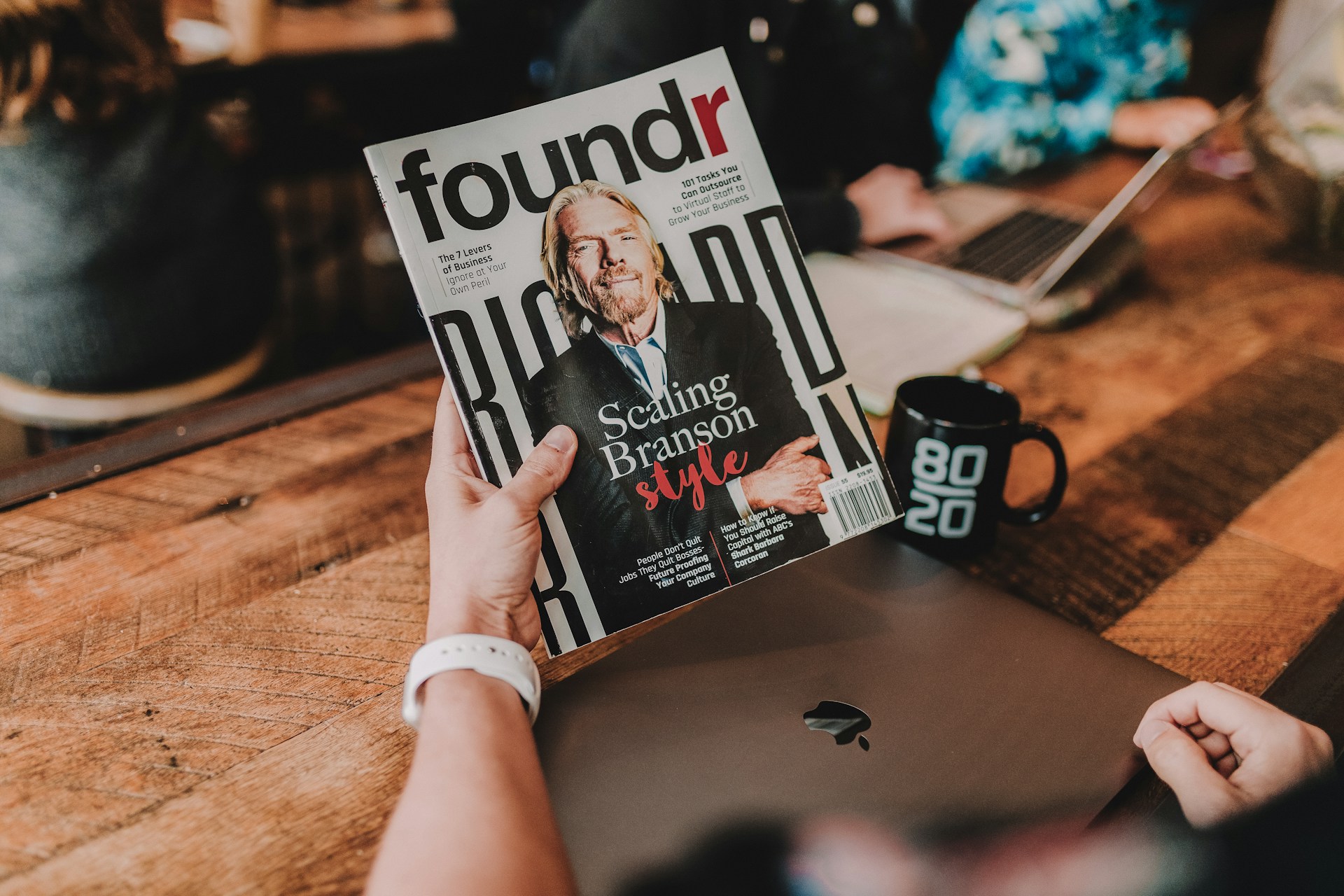 person holding founder book weekly review for personal development