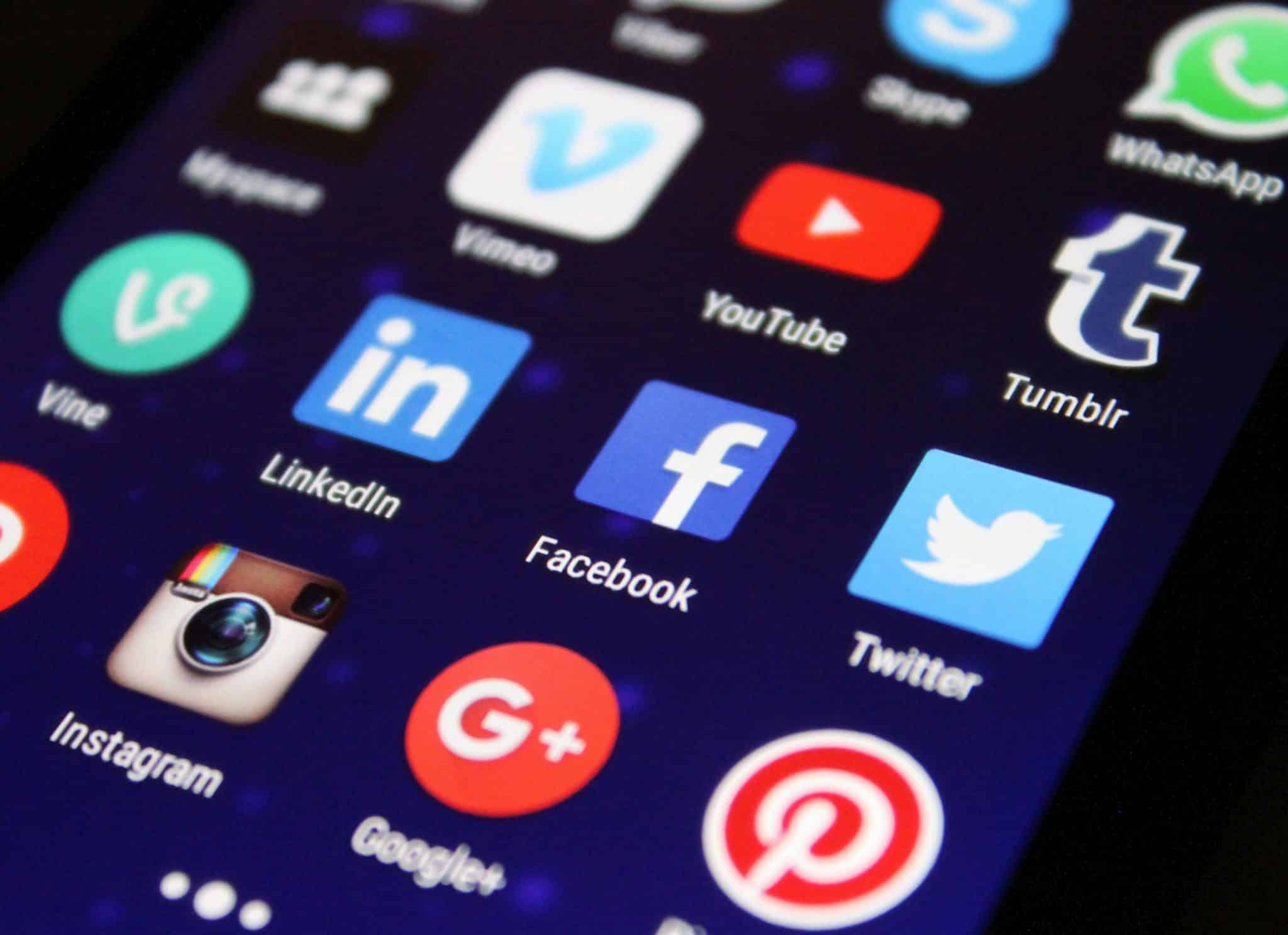 Close-up of a smartphone screen displaying various app icons, representing digital connectivity and constant notifications.