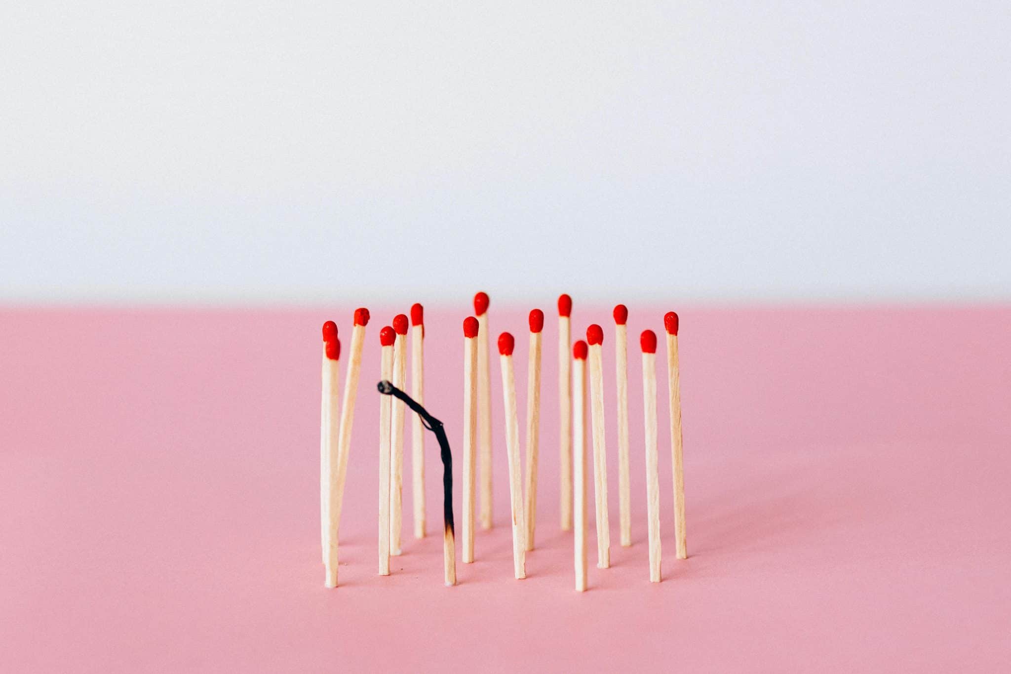 Visual metaphor for burnout and recovery showing matchsticks in various states, symbolizing energy depletion and the path to restored focus.