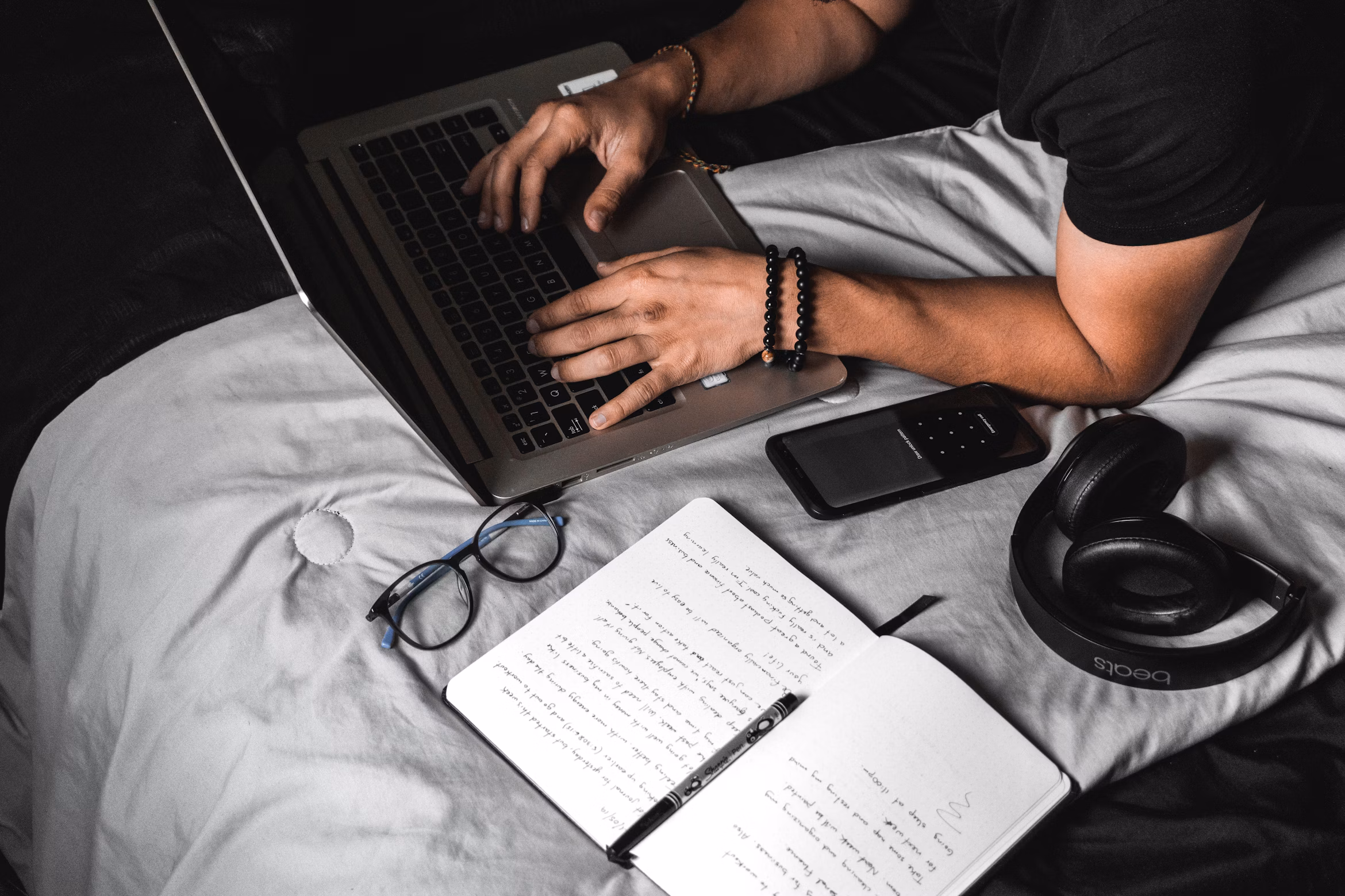 Space gray MacBook on a wooden desk, open and ready for a locked-in, distraction-free work session.
