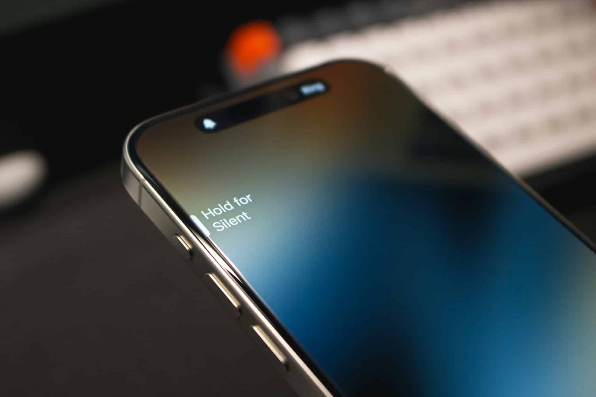 Close-up of a smartphone and keyboard symbolizing digital overwhelm and anxiety from constant connectivity