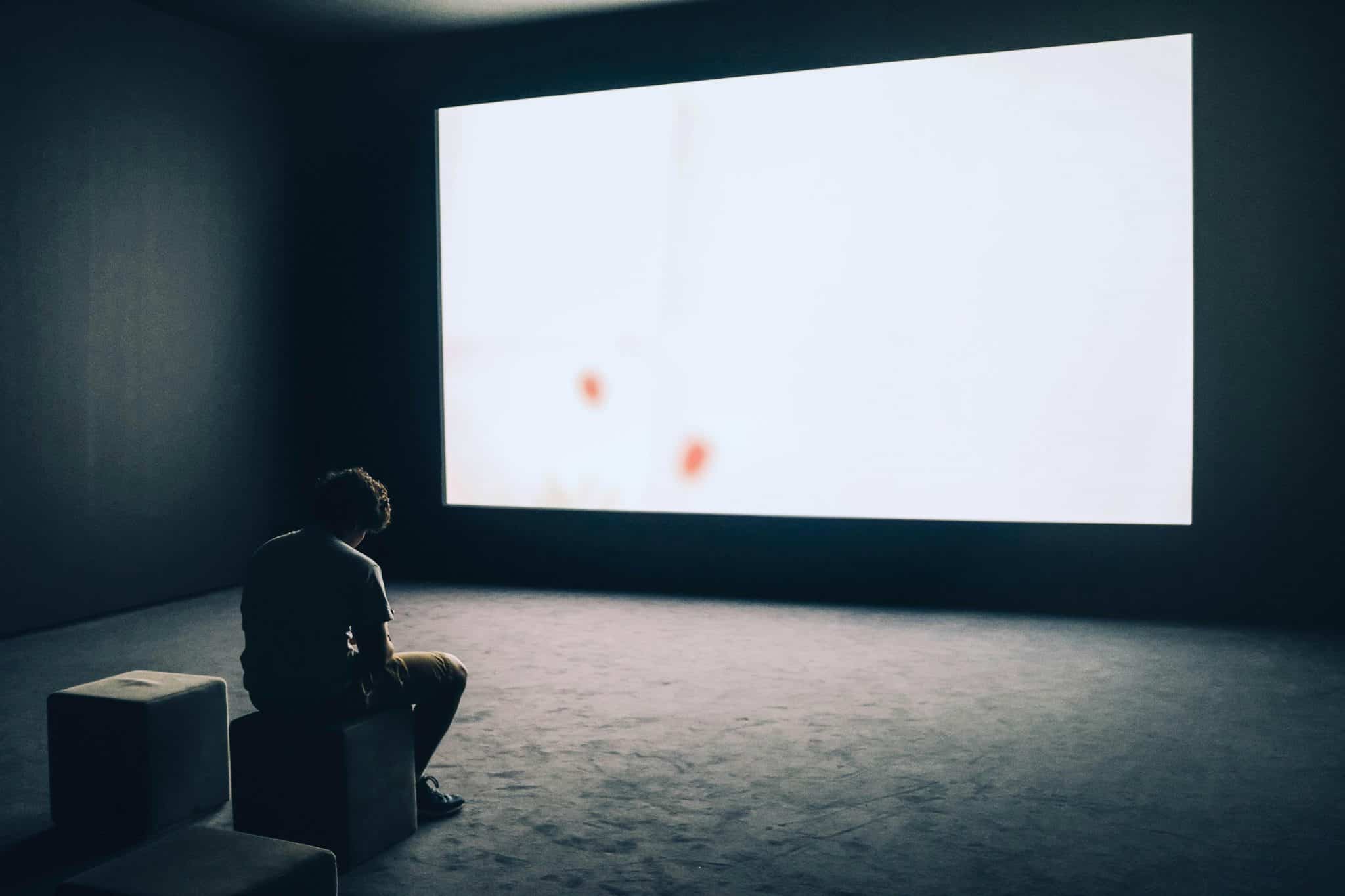 Man staring at a glowing computer screen, showing overstimulation before starting dopamine fasting to reduce screen fatigue.