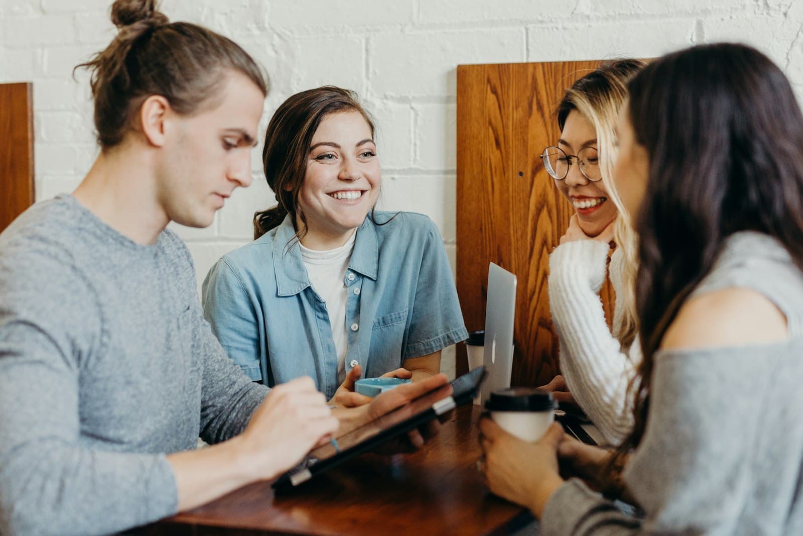 A group of friends talking together at a coffee shop table